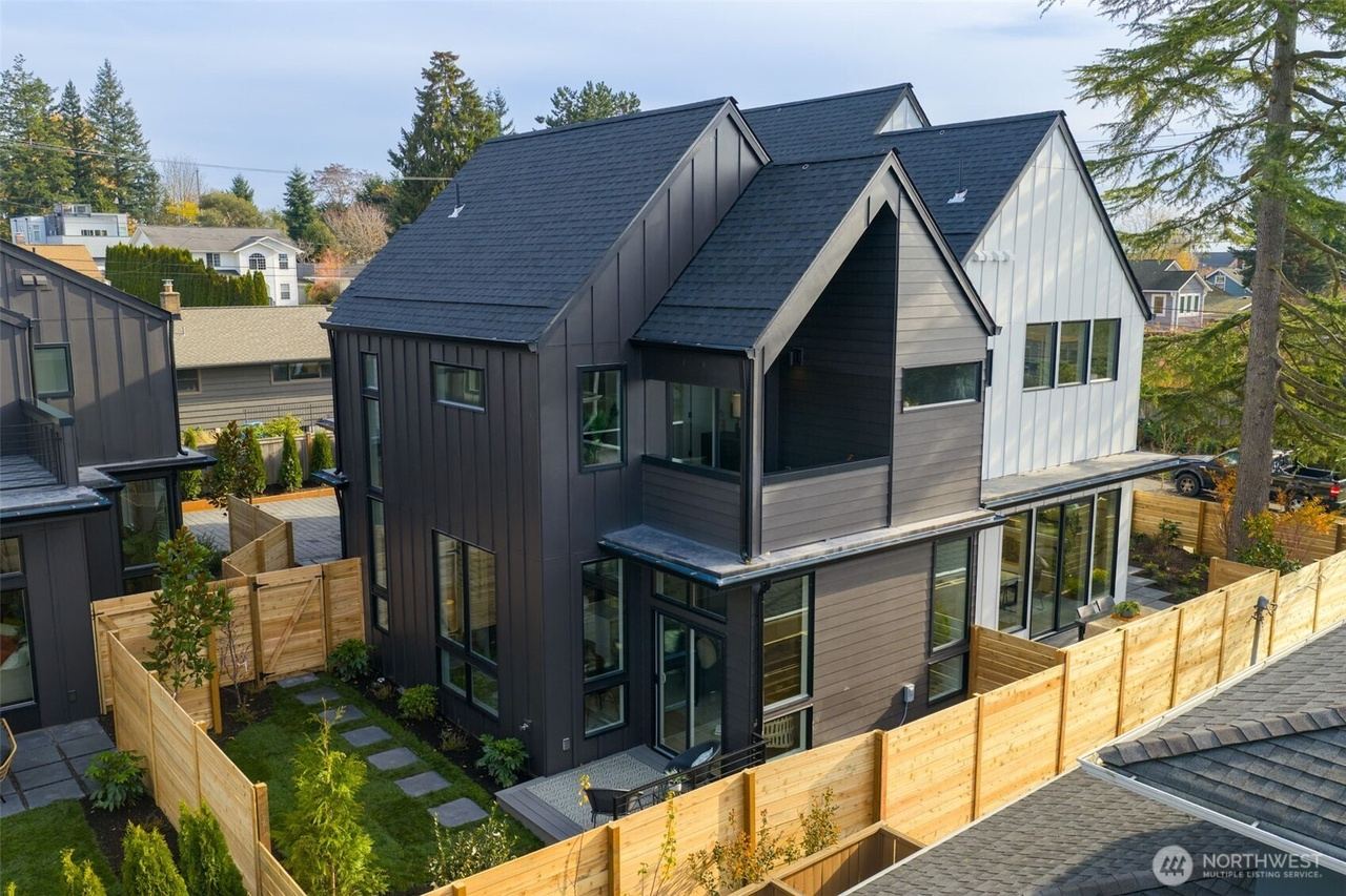 Two-story dark-clad gabled home viewed from above
